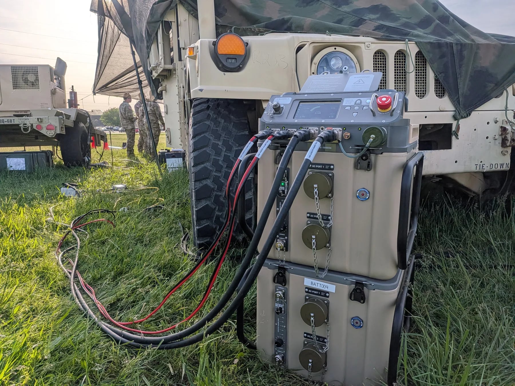 Stacked HYPER™ power and battery module units in front of a military vehicle